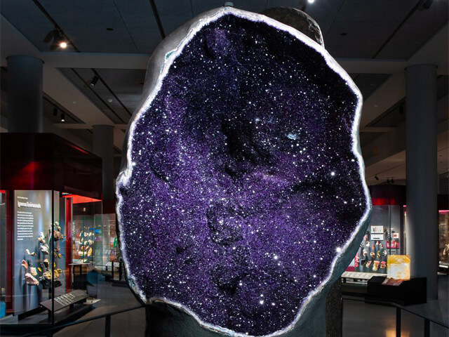 Glittering amethyst crystals on the interior of a geode at the entry of the Mignone Halls of Gems and Minerals